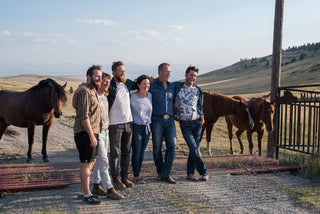 Mitchell Bros. Beef ranchers standing together next to their horses.
