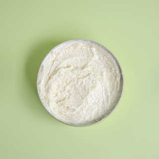 Whipped tallow sugar scrub with green background.