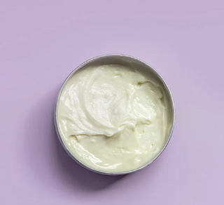 Whipped tallow body butter with purple background.