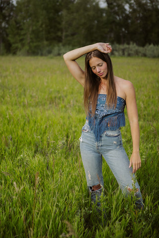 Founder of Fatskn Inc., Caitlin Warrington, standing in a pasture of grass.