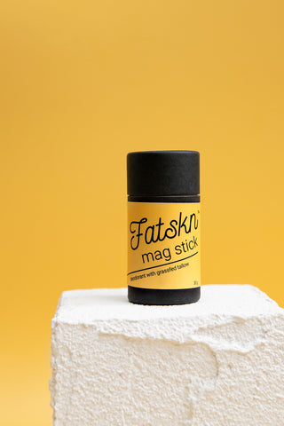Fatskn magnesium tallow balm stick on a block of grassfed suet tallow.