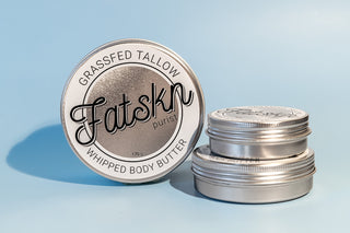 Fatskn Purist grassfed tallow whipped body butter in all sizes with a blue background.