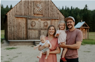 Vanderkley Valley Farm ranchers and their family standing in front of a barn.